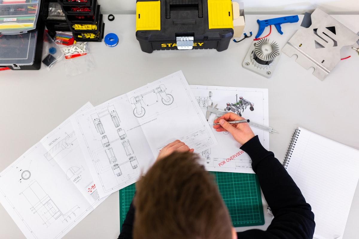 Technician repairing a mechanical device at a workbench