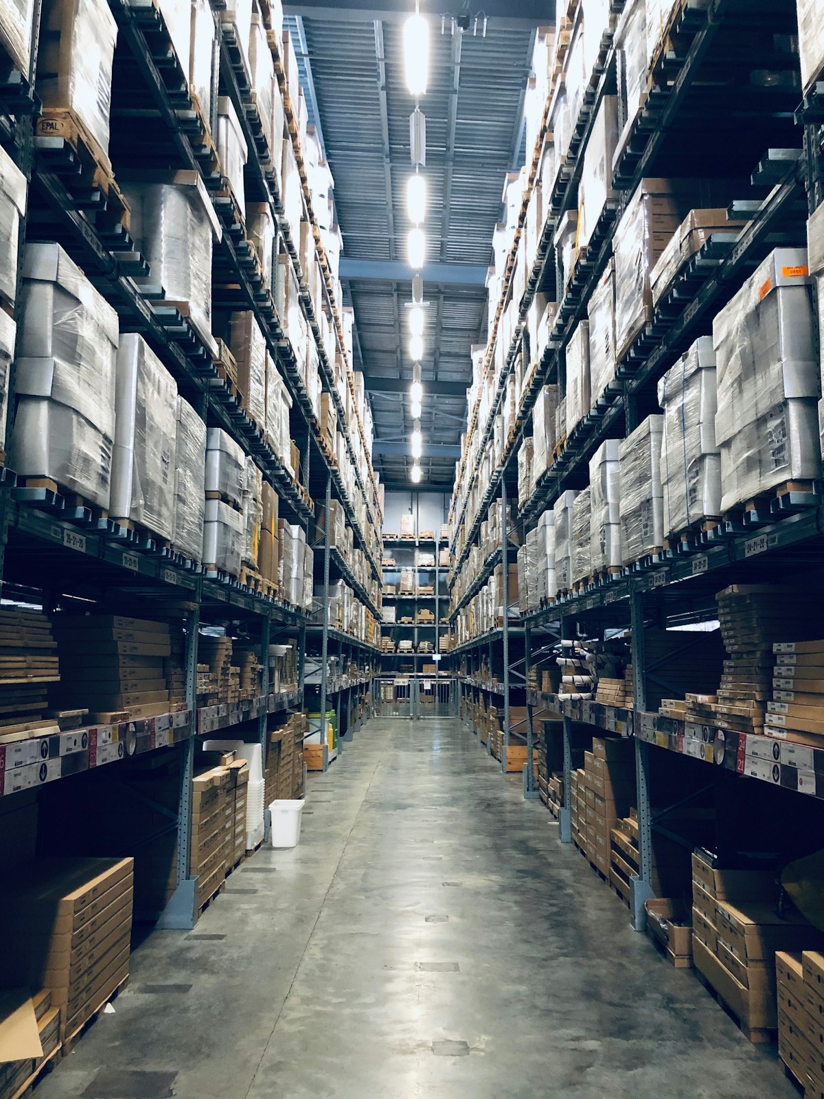 Warehouse aisle with shelving and packages for returns processing